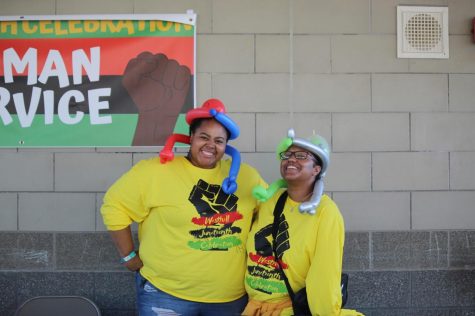 Photo of MyKaLa Alexander and Bria Nolan smiling while showing off their balloon hats.