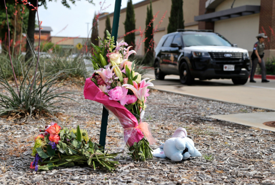 Photo of flowers and stuffed animals left at Allen Premium Outlets on May 7th, from Stewart F. House/Getty Images.