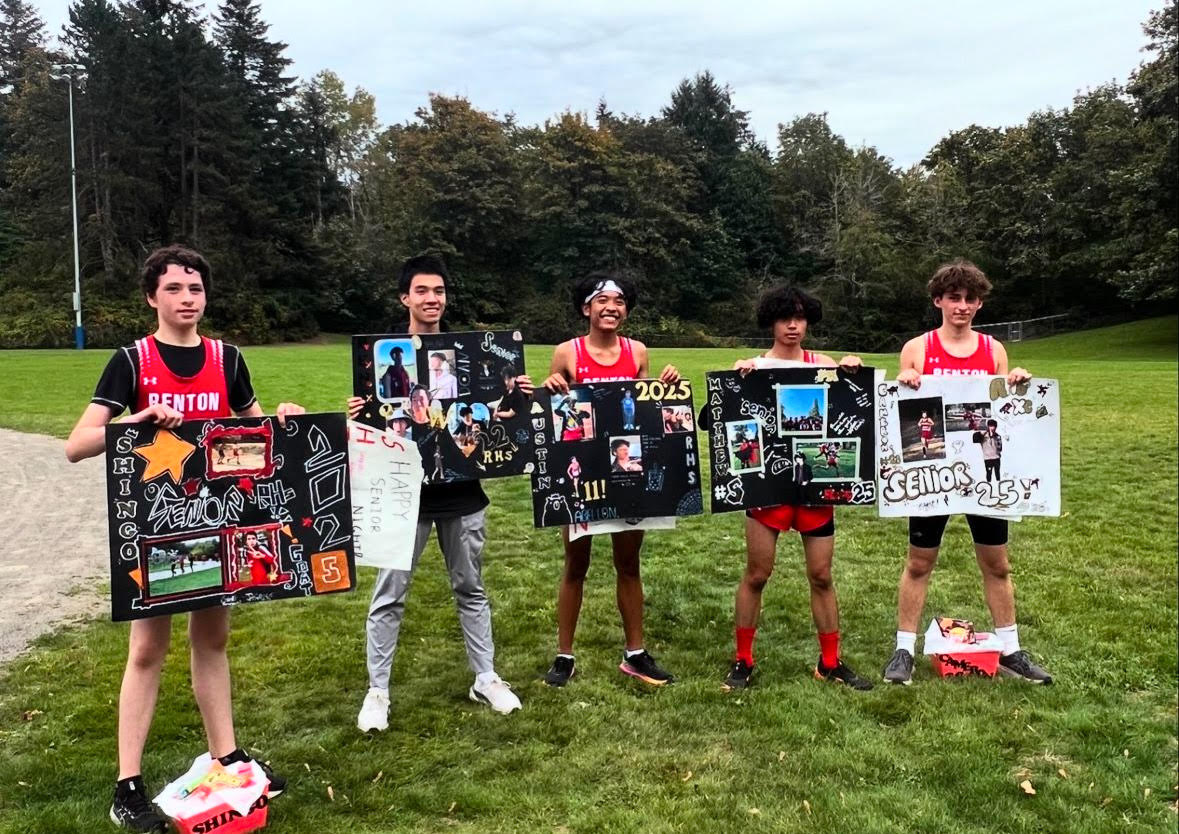 Picture of the cross-country seniors with their personalized posters.