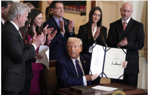 Picture of President Trump signing the new Laken Riley Law into act.