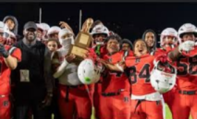 Picture of RHS Football Team with their “Battle of the Birds” trophy after winning their game against Lindbergh HS.   