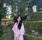 Nhu San wearing a traditional Vietnamese dress known as Áo Dài