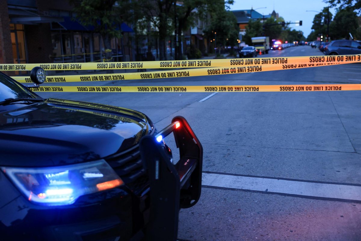 Photo of a police car and crime scene tape.