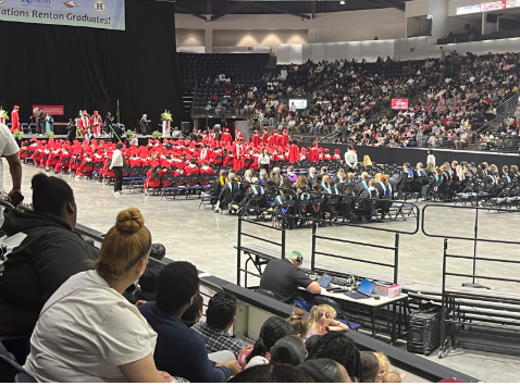 Picture of inside of the Accesso Showare Center looking behind the RHS staff and RHS graduates of 2025.