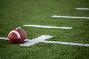 Photo of a football resting on the field.