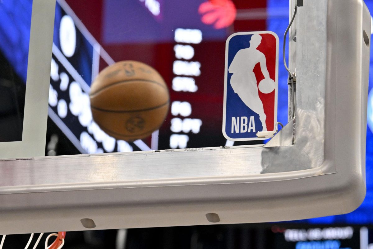 A photo of a basketball with the NBA sign next to it. 