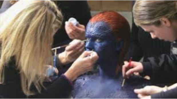 Photo of SFX makeup artists adding details to Jennifer Lawrence for X-men.