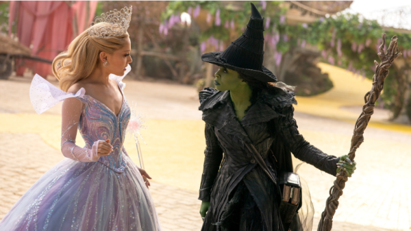 Photo snapshot of Glinda (Ariana Grande) and Elphaba (Cynthia Erivo).
