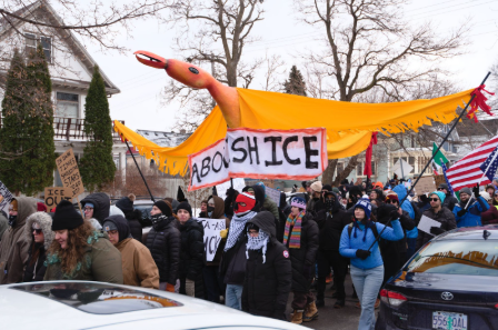 Photo of a protest with a sign stating "ABOLISH ICE".
