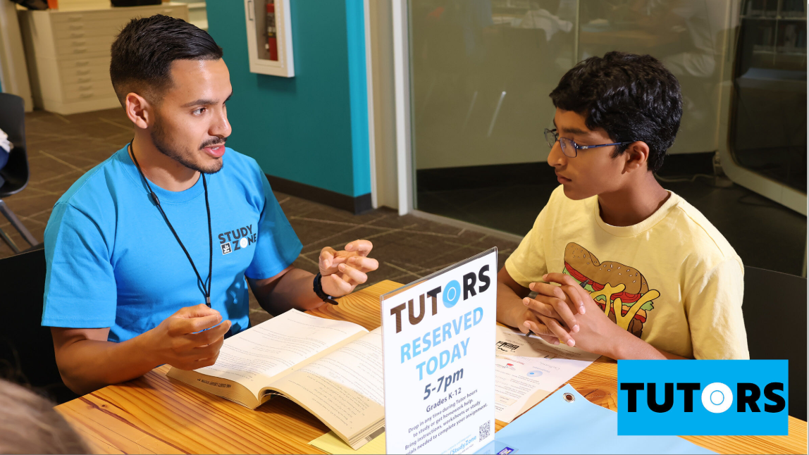 Photo of a tutor helping a student.