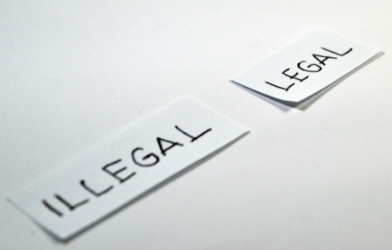 Photo of two cards that read "legal" and "illegal."