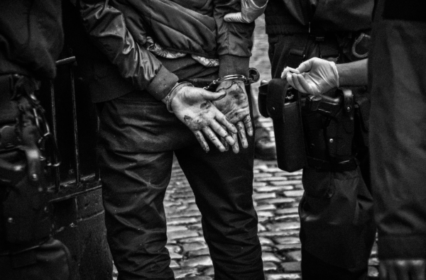 Photo of a person's hands in handcuffs.