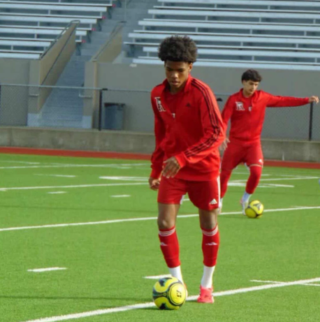 Photo of sophomore center midfielder Princeton Montgomery warming up before a soccer game.