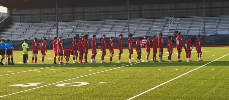 Photo of the Renton soccer team pregame during the National Anthem.