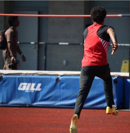 Photo of Kevin Heard approaching the bar For high jump.