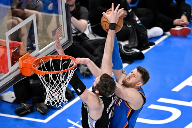 Photo of Spurs Center Luke Kornet chasing Thunder Center Isaiah Hartenstien down and blocking his shot off the backboard, This play was one of the most important plays in this game.