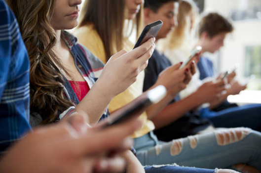 Photo of students on their phones.