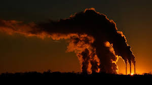 Photo of factory towers emitting smoke.